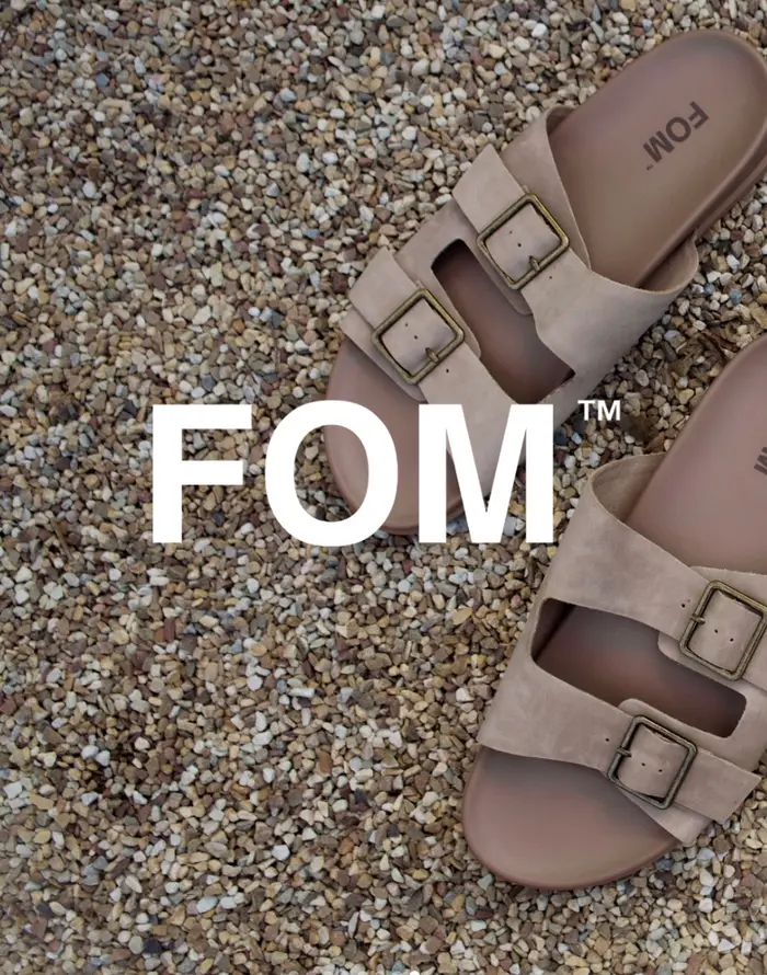 A pair of FOM suede buckle sandals on gravel
